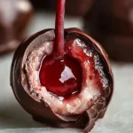 Close-up of chocolate dipped cherry showing juicy center